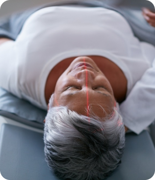 Patient receiving neurological support treatment with laser therapy, focusing on brain and nervous system evaluation at Apex Chiropractic & Wellness Center.